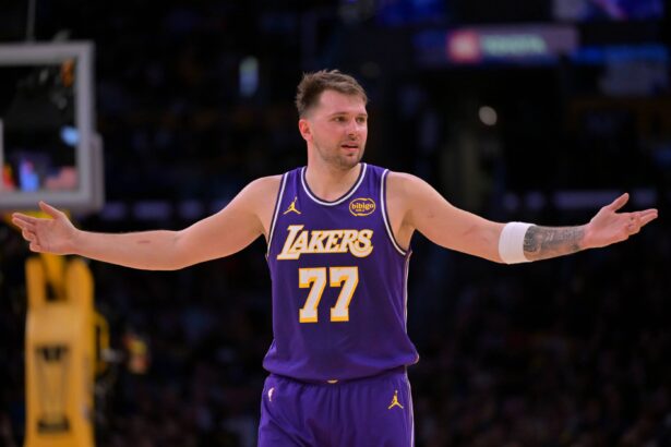 Los Angeles, California, USA; Los Angeles Lakers guard Luka Doncic (77) reacts after a foul on Dallas Mavericks forward Naji Marshall (13) in the second half at Crypto.com Arena. Mandatory Credit: Jayne Kamin-Oncea-Imagn Images
