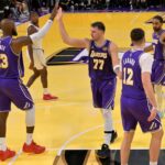 Los Angeles, California, USA; Los Angeles Lakers forward LeBron James (23) and guard Luka Doncic (77) high five during a time out in the second half against the Los Angeles Clippers at Crypto.com Arena. Mandatory Credit: Jayne Kamin-Oncea-Imagn Images