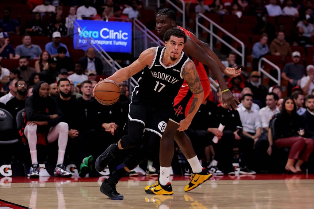 Houston, Texas, USA; Brooklyn Nets forward Michael Porter Jr. (17) drives to the basket against Houston Rockets center Clint Capela (30) during the fourth quarter at Toyota Center. Mandatory Credit: Erik Williams-Imagn Images