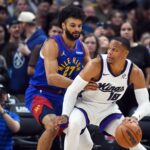 Denver, Colorado, USA; Sacramento Kings guard Russell Westbrook (18) handles the ball against Denver Nuggets guard Jamal Murray (27) during the first half at Ball Arena. Mandatory Credit: Christopher Hanewinckel-Imagn Images