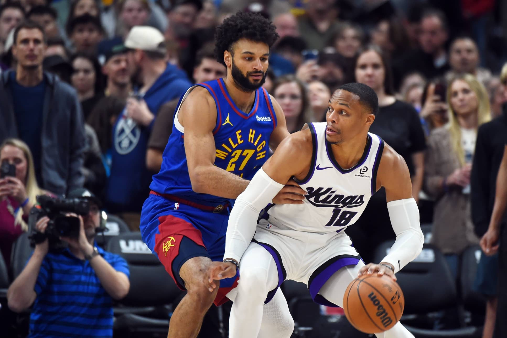 Denver, Colorado, USA; Sacramento Kings guard Russell Westbrook (18) handles the ball against Denver Nuggets guard Jamal Murray (27) during the first half at Ball Arena. Mandatory Credit: Christopher Hanewinckel-Imagn Images