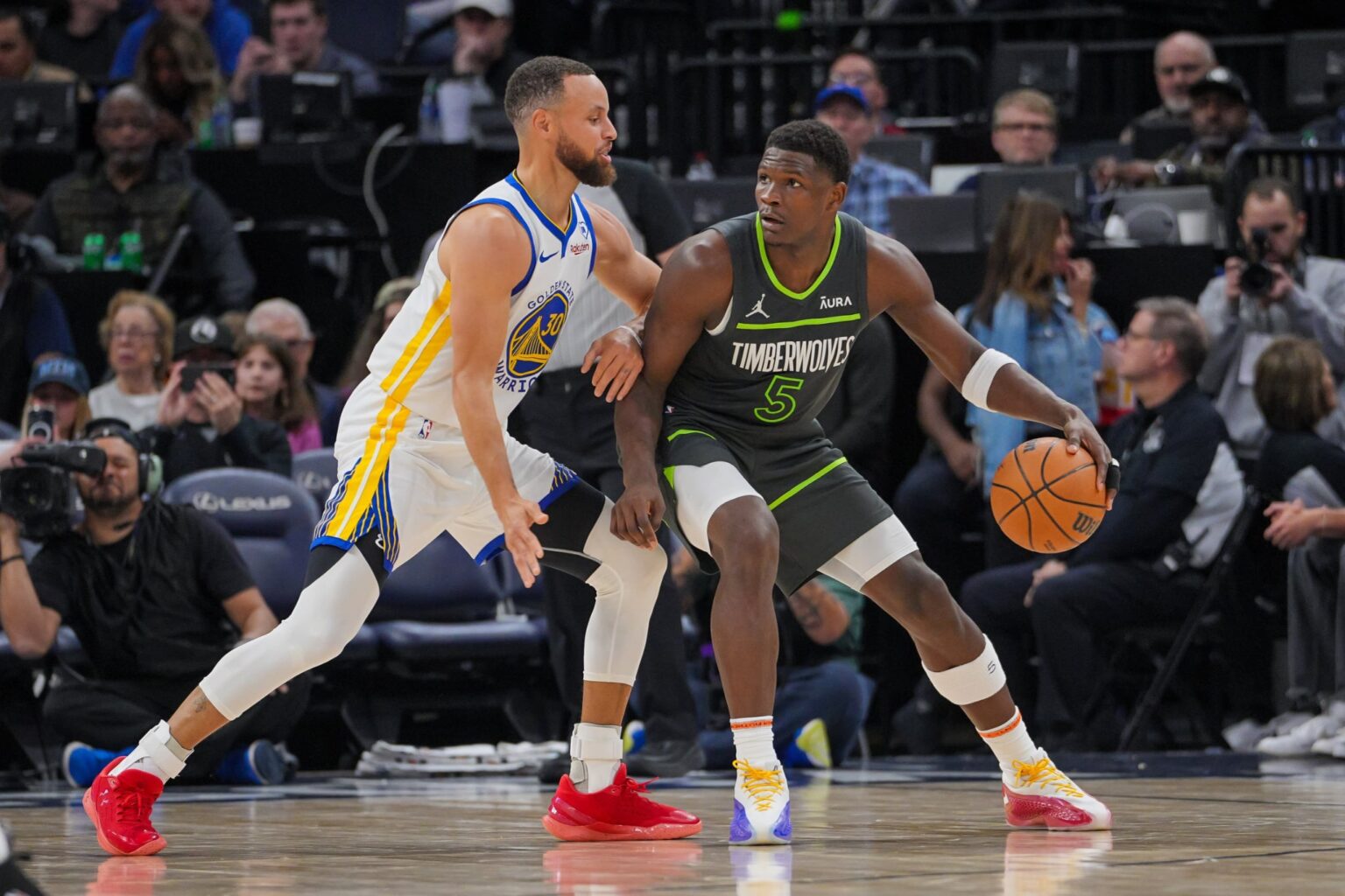 Mar 24, 2024; Minneapolis, Minnesota, USA; Golden State Warriors guard Stephen Curry (30) defends Minnesota Timberwolves guard Anthony Edwards (5) in the third quarter at Target Center. Mandatory Credit: Brad Rempel-Imagn Images