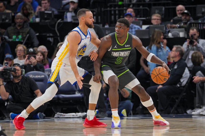 Mar 24, 2024; Minneapolis, Minnesota, USA; Golden State Warriors guard Stephen Curry (30) defends Minnesota Timberwolves guard Anthony Edwards (5) in the third quarter at Target Center. Mandatory Credit: Brad Rempel-Imagn Images