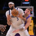 Dallas Mavericks forward Anthony Davis (3) is defended by Los Angeles Lakers guard Luka Doncic (77) as he handles the ball in the second half at Crypto.com Arena.