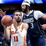 Atlanta Hawks guard Trae Young (11) looks to pass as Dallas Mavericks forward Anthony Davis (3) defends during the fourth quarter at American Airlines Center.