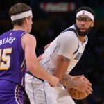 Los Angeles Lakers guard Austin Reaves (15) defends Dallas Mavericks forward Anthony Davis (3) in the second half at Crypto.com Arena.