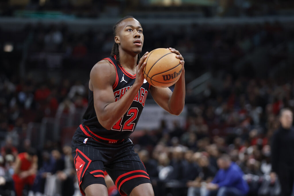 Mar 25, 2024; Chicago, Illinois, USA; Chicago Bulls guard Ayo Dosunmu (12) shoots a free throw against the Washington Wizards during the first half at United Center. Mandatory Credit: Kamil Krzaczynski-Imagn Images