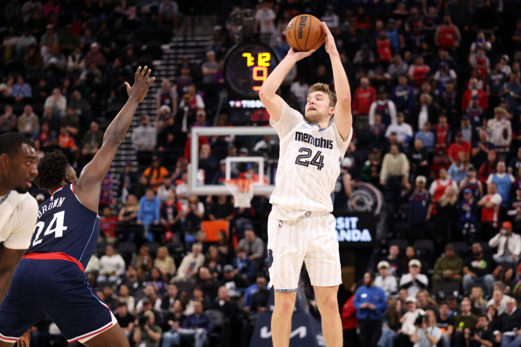 Dec 15, 2025; Inglewood, California, USA; Memphis Grizzlies guard Cam Spencer (24) shoots the ball against Los Angeles Clippers forward Kobe Brown (24) during the second half at Intuit Dome. Mandatory Credit: Kiyoshi Mio-Imagn Images