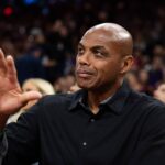 Phoenix Suns former player Charles Barkley sits courtside against the Minnesota Timberwolves during an NBA Cup game at Mortgage Matchup Center.