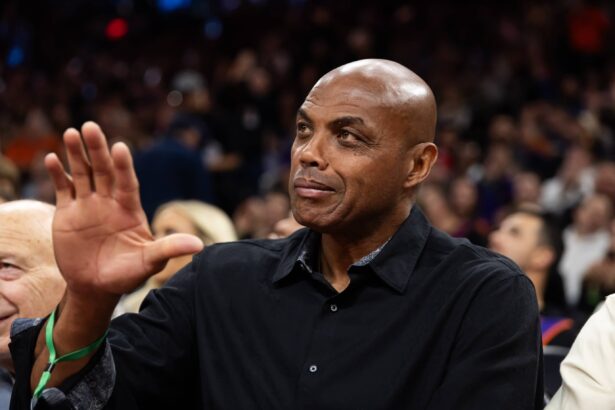 Phoenix Suns former player Charles Barkley sits courtside against the Minnesota Timberwolves during an NBA Cup game at Mortgage Matchup Center.