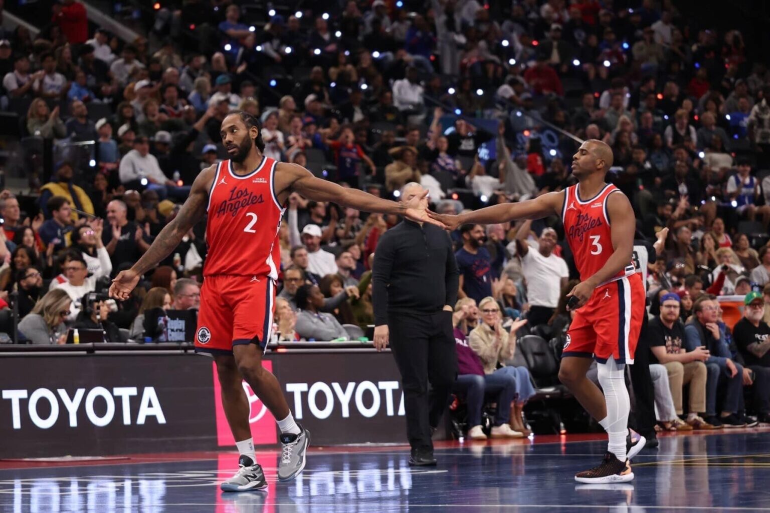 Nov 28, 2025; Inglewood, California, USA; Los Angeles Clippers forward Kawhi Leonard (2) high-fives guard Chris Paul (3) during the second half against the Memphis Grizzlies at Intuit Dome. Mandatory Credit: Kiyoshi Mio-Imagn Images