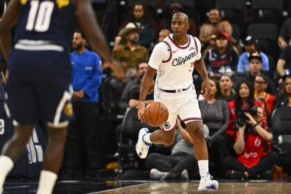 Oct 12, 2025; Inglewood, California, USA; Los Angeles Clippers guard Chris Paul (3) moves the ball against Denver Nuggets guard/forward Tim Hardaway Jr. (10) during the first quarter at Intuit Dome. Mandatory Credit: Jonathan Hui-Imagn Images