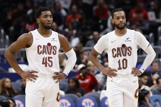 Dec 12, 2025; Washington, District of Columbia, USA; Cleveland Cavaliers guard Donovan Mitchell (45) stands next to Cavaliers guard Darius Garland (10) on court during a stoppage in play against the Washington Wizards in the second half at Capital One Arena. Mandatory Credit: Geoff Burke-Imagn Images