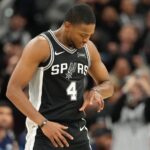 Dec 2, 2025; San Antonio, Texas, USA; San Antonio Spurs guard De’Aaron Fox (4) reacts after scoring a three point basket during the second half against the Memphis Grizzlies at Frost Bank Center. Mandatory Credit: Scott Wachter-Imagn Images