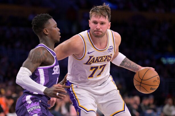 Dec 28, 2025; Los Angeles, California, USA; Sacramento Kings guard Dennis Schroder (17) defemds Los Angeles Lakers guard Luka Doncic (77) in the second half at Crypto.com Arena. Mandatory Credit: Jayne Kamin-Oncea-Imagn Images