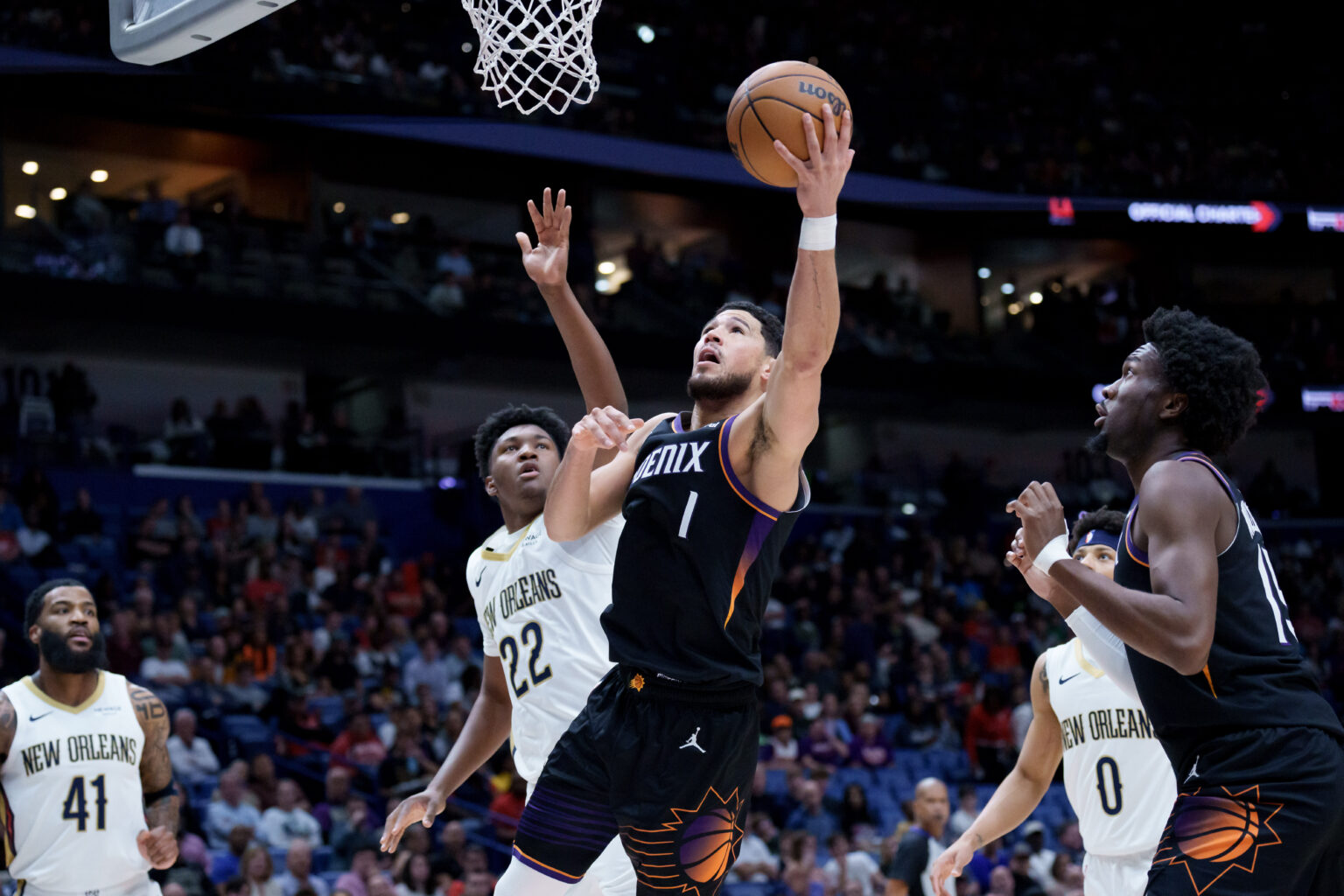 Dec 26, 2025; New Orleans, Louisiana, USA; Phoenix Suns guard Devin Booker (1) shoot against New Orleans Pelicans center Derik Queen (22) at Smoothie King Center. Mandatory Credit: Matthew Hinton-Imagn Images