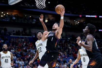 Dec 26, 2025; New Orleans, Louisiana, USA; Phoenix Suns guard Devin Booker (1) shoot against New Orleans Pelicans center Derik Queen (22) at Smoothie King Center. Mandatory Credit: Matthew Hinton-Imagn Images