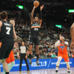 Dec 23, 2025; San Antonio, Texas, USA; San Antonio Spurs guard Devin Vassell (24) shoots during the first half against the Oklahoma City Thunder at Frost Bank Center. Mandatory Credit: Scott Wachter-Imagn Images