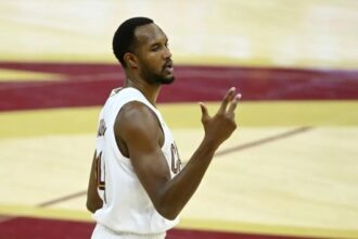 Dec 3, 2025; Cleveland, Ohio, USA; Cleveland Cavaliers center Evan Mobley (4) celebrates a three-point basket in the fourth quarter against the Portland Trail Blazers at Rocket Arena. Mandatory Credit: David Richard-Imagn Images