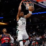 Dec 1, 2025; Washington, District of Columbia, USA; Milwaukee Bucks forward Giannis Antetokounmpo (34) dunks the ball as Washington Wizards forward Khris Middleton (22) looks on in the second quarter at Capital One Arena. Mandatory Credit: Geoff Burke-Imagn Images