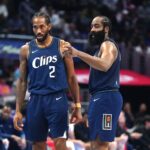 Nov 24, 2023; Los Angeles, California, USA; LA Clippers forward Kawhi Leonard (2) and guard James Harden (1) talk during their game against the New Orleans Pelicans in the second half at Crypto.com Arena. Mandatory Credit: Kirby Lee-Imagn Images