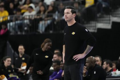 Oct 15, 2025; Las Vegas, Nevada, USA; Los Angeles Lakers head coach JJ Redick watches from the bench during the first half against the Dallas Mavericks at T-Mobile Arena. Mandatory Credit: Lucas Peltier-Imagn Images