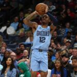 Mar 31, 2025; Memphis, Tennessee, USA; Memphis Grizzlies guard Ja Morant (12) shoots for three during the fourth quarter against the Boston Celtics at FedExForum. Mandatory Credit: Petre Thomas-Imagn Images