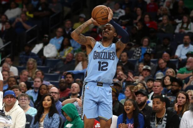 Mar 31, 2025; Memphis, Tennessee, USA; Memphis Grizzlies guard Ja Morant (12) shoots for three during the fourth quarter against the Boston Celtics at FedExForum. Mandatory Credit: Petre Thomas-Imagn Images