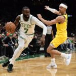 Dec 22, 2025; Boston, Massachusetts, USA; Boston Celtics guard Jaylen Brown (7) controls the ball while Indiana Pacers guard Andrew Nembhard (2) defends during the second half at TD Garden. Mandatory Credit: Bob DeChiara-Imagn Images
