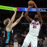 Dec 30, 2025; Memphis, Tennessee, USA; Philadelphia 76ers center Joel Embiid (21) shoots as Memphis Grizzlies center Jock Landale (31) defends during the second quarter at FedExForum. Mandatory Credit: Petre Thomas-Imagn Images