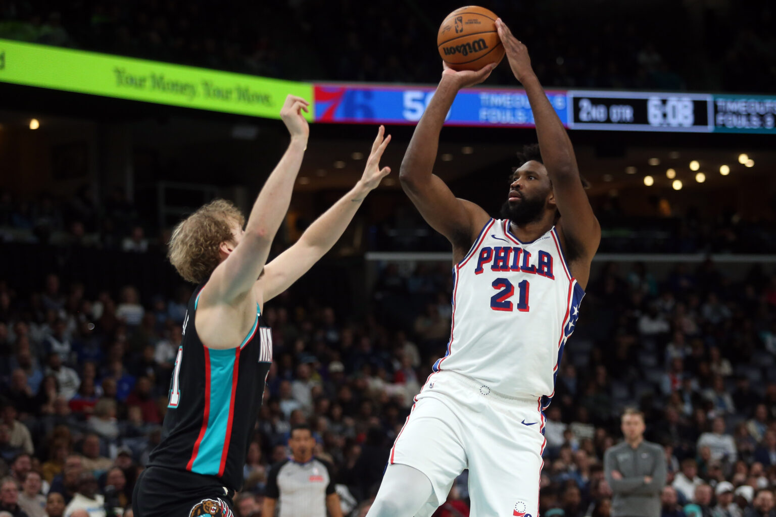 Dec 30, 2025; Memphis, Tennessee, USA; Philadelphia 76ers center Joel Embiid (21) shoots as Memphis Grizzlies center Jock Landale (31) defends during the second quarter at FedExForum. Mandatory Credit: Petre Thomas-Imagn Images