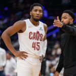 Cleveland Cavaliers guard Donovan Mitchell (45) speaks to Cleveland Cavaliers associate head coach Johnnie Bryant during a time out in the third quarter against the Washington Wizards at Capital One Arena.