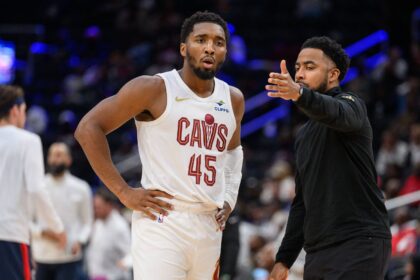 Cleveland Cavaliers guard Donovan Mitchell (45) speaks to Cleveland Cavaliers associate head coach Johnnie Bryant during a time out in the third quarter against the Washington Wizards at Capital One Arena.