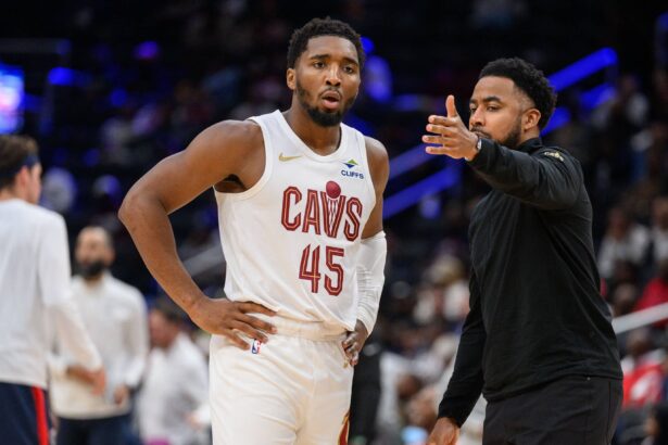 Cleveland Cavaliers guard Donovan Mitchell (45) speaks to Cleveland Cavaliers associate head coach Johnnie Bryant during a time out in the third quarter against the Washington Wizards at Capital One Arena.