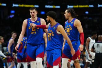 Mar 3, 2023; Denver, Colorado, USA; Denver Nuggets center Nikola Jokic (15) and guard Jamal Murray (27) and forward Aaron Gordon (50) celebrate after defeating the Memphis Grizzlies at Ball Arena. Mandatory Credit: Ron Chenoy-Imagn Images
