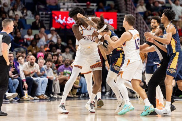 Dec 27, 2025; New Orleans, Louisiana, USA; New Orleans Pelicans guard Jose Alvarado (15) gets into a scrum with Phoenix Suns center Mark Williams (15) over a play during the second half at Smoothie King Center. Mandatory Credit: Stephen Lew-Imagn Images