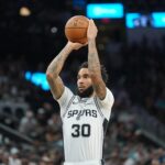 Nov 16, 2025; San Antonio, Texas, USA; San Antonio Spurs forward Julian Champagnie (30) shoots a free throw in the first half against the Sacramento Kings at Frost Bank Center. Mandatory Credit: Daniel Dunn-Imagn Images