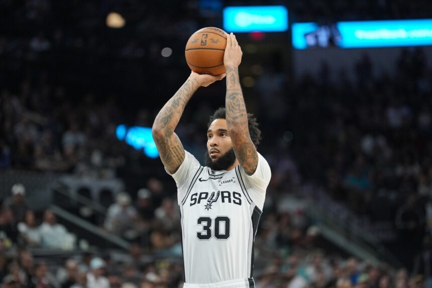 Nov 16, 2025; San Antonio, Texas, USA; San Antonio Spurs forward Julian Champagnie (30) shoots a free throw in the first half against the Sacramento Kings at Frost Bank Center. Mandatory Credit: Daniel Dunn-Imagn Images