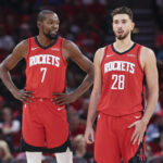 Oct 24, 2025; Houston, Texas, USA; Houston Rockets forward Kevin Durant (7) talks with center Alperen Sengun (28) during the first quarter against the Detroit Pistons at Toyota Center. Mandatory Credit: Troy Taormina-Imagn Images