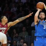 Dallas Mavericks guard Klay Thompson (31) takes a three-point shot as Miami Heat forward Keshad Johnson (16) closes in during the second half at Kaseya Center.