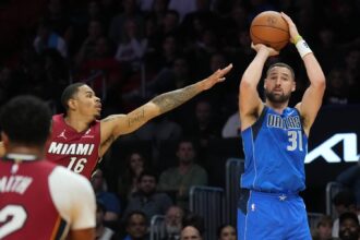 Dallas Mavericks guard Klay Thompson (31) takes a three-point shot as Miami Heat forward Keshad Johnson (16) closes in during the second half at Kaseya Center.