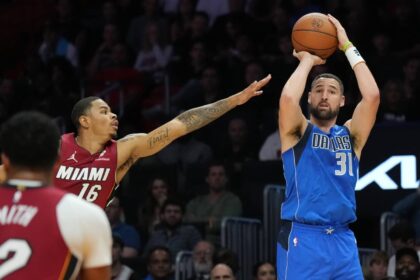 Dallas Mavericks guard Klay Thompson (31) takes a three-point shot as Miami Heat forward Keshad Johnson (16) closes in during the second half at Kaseya Center.
