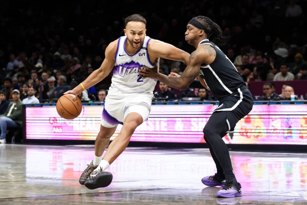 Dec 4, 2025; Brooklyn, New York, USA; Utah Jazz forward Kyle Anderson (2) moves the ball past Brooklyn Nets guard Terance Mann (14) during the fourth quarter at Barclays Center. Mandatory Credit: Tom Horak-Imagn Images