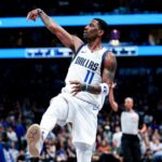 Feb 27, 2025; Dallas, Texas, USA; Dallas Mavericks guard Kyrie Irving (11) reacts after shooting against the Charlotte Hornets during the second half at American Airlines Center. Mandatory Credit: Kevin Jairaj-Imagn Images