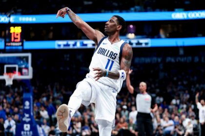 Feb 27, 2025; Dallas, Texas, USA; Dallas Mavericks guard Kyrie Irving (11) reacts after shooting against the Charlotte Hornets during the second half at American Airlines Center. Mandatory Credit: Kevin Jairaj-Imagn Images