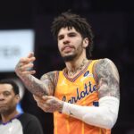 Charlotte Hornets guard LaMelo Ball (1) rubs his elbow after falling during the second half against the Atlanta Hawks at the Spectrum Center.