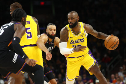 Dec 23, 2025; Phoenix, Arizona, USA; Los Angeles Lakers forward LeBron James (23) moves the ball against Phoenix Suns forward Dillon Brooks in the second half at Mortgage Matchup Center. Mandatory Credit: Mark J. Rebilas-Imagn Images