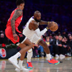 Dec 25, 2025; Los Angeles, California, USA; Los Angeles Lakers forward LeBron James (23) moves the ball against Houston Rockets forward Jabari Smith Jr. (10) during the first half at Crypto.com Arena. Mandatory Credit: Gary A. Vasquez-Imagn Images
