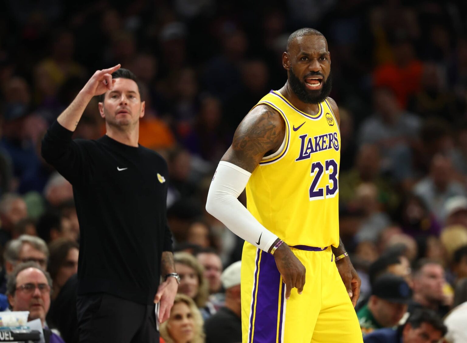 Los Angeles Lakers forward LeBron James (23) and head coach JJ Redick against the Phoenix Suns in the first half at Mortgage Matchup Center.