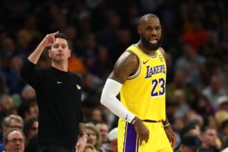 Los Angeles Lakers forward LeBron James (23) and head coach JJ Redick against the Phoenix Suns in the first half at Mortgage Matchup Center.